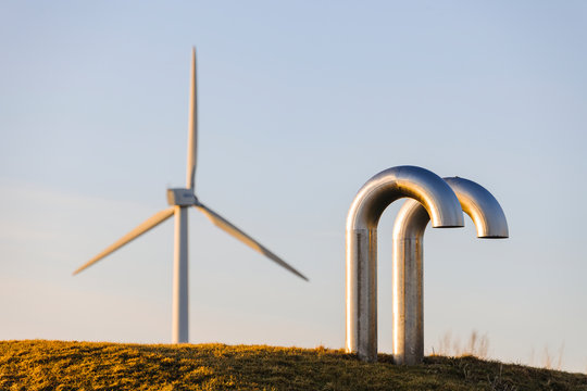 Pipes, wind turbine on background