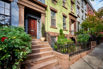 a view of a row of historic brownstones in an iconic neighborhood of Manhattan, New York City