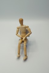 Drawing Mannequin sitting on toilet in distress 