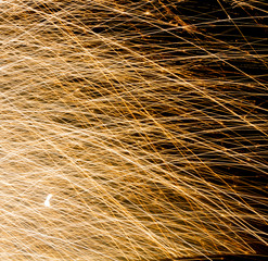 Golden fireworks against dark background 