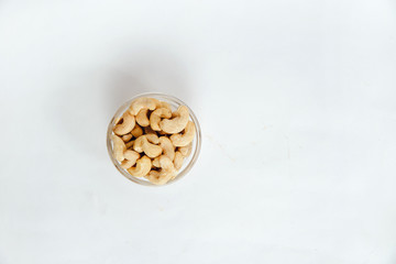 Cashews on a bright white background. The concept of eating nuts, giving them to a meal.
