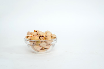 Nuts pistachios on a white background. The concept of eating nuts, giving them to a meal.