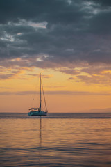 Small yacht in the red  sea at sunset in weilat ,israel 2019.