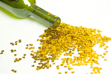 golden heart spills out of the neck of a wine bottle