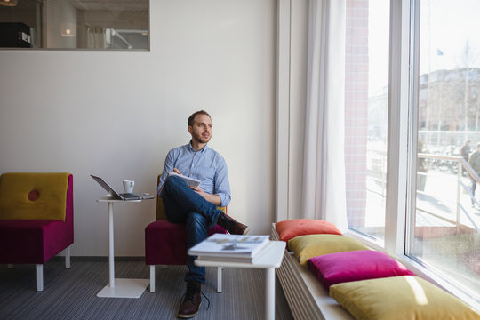 Man looking through window