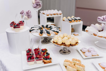 Tasty selection of delicious desserts, cakes, cupcakes and pastry on a buffet table at banquet, party or wedding