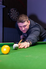 young man playing snooker