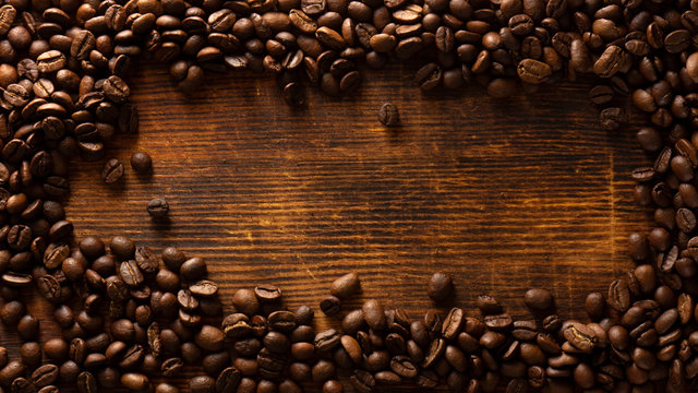 coffee seeds on yellow wooden background closeup