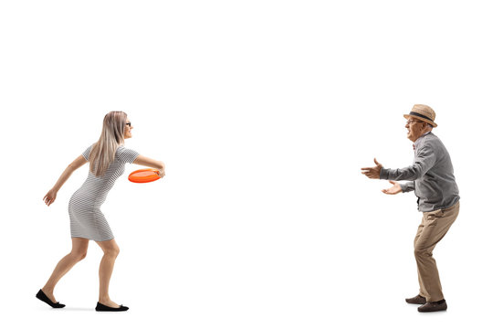 Yung woman and an elderly man playing with a flying disc