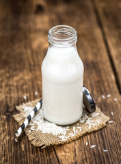 Vintage wooden table with Rice Milk (selective focus; close-up shot)
