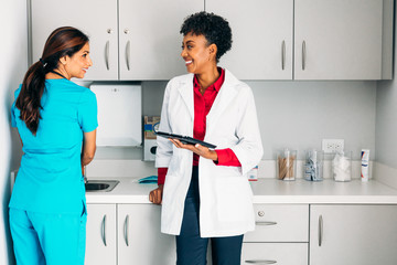 Nurse talking to doctor in exam room