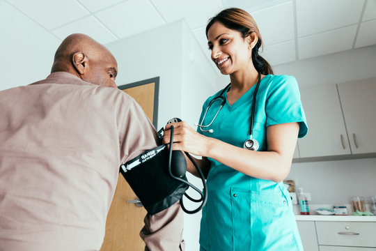 Doctor checking heart rate and blood pressure