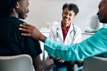 Doctor consulting young patient and grandmother