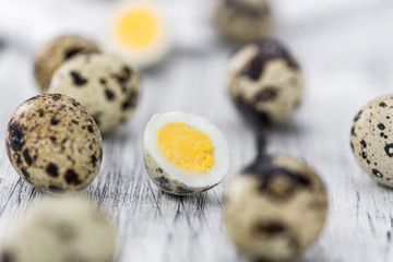 Some fresh Quail Eggs on wooden background (selective focus; close-up shot)