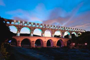 Aqueduct Pont du Gard in the Provence in France colorful illuminated at night