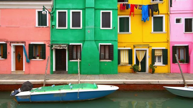 Laundry hanging to dry from clothesline in colorful neighborhood on Burano Island, Venice, Italy - slow slider