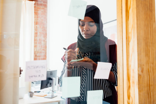 Woman brainstorming and taking notes