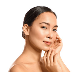 Portrait of young Asian woman with healthy skin on white background