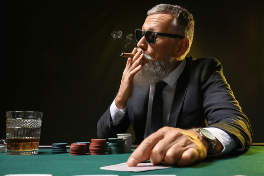 Mature businessman playing in casino