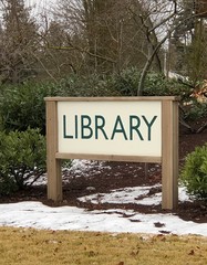 Public library sign in front of the library building