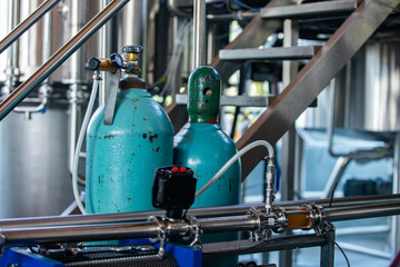 two liquid nitrogen tanks plugged on a brewery piping systems and temperature and pressure measuring devices and electrical wiring