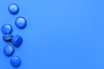 Blue macarons on color background