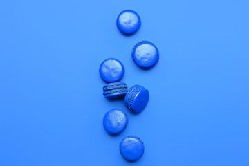 Blue macarons on color background