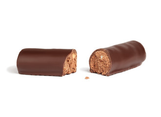Hazelnut candy broken into two halves on white