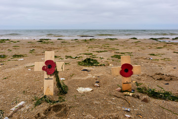Wooden cross in the sand at Utah Beach in the Normandy to remember the deaths of the second world war