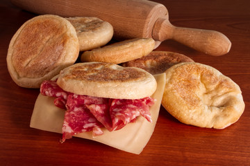 Tigelle on wooden table. Traditional italian food from Emilia-Romagna region.