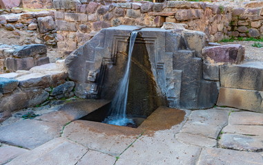 A fountain ruins carved in stone  called the bath of the princess, Ollantaytambo Archaeological Park, Peru