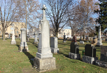 Fototapeta premium Obelisks with other graves at a small suburban Chicago cemetery