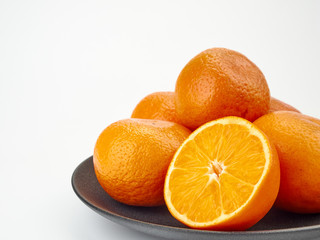 Tangerines or orange Mandarin fruit and peeled slices. A bunch of oranges and half.