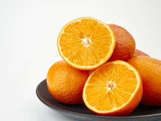 Tangerines or orange Mandarin fruit and peeled slices. A bunch of oranges and half.