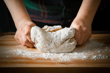 The chef prepares pizza dough