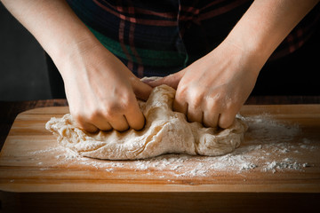 The chef prepares pizza dough