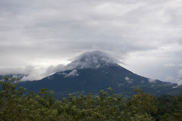 Fototapeta premium Arenal Volcano With Clouds Blue Sky Sunset