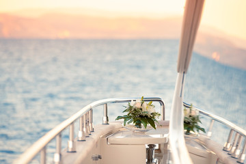 Selective focus shot of white flowers on the yacht