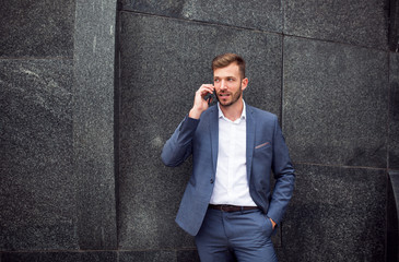 Portrait of smart businessman in suit talking on the phone