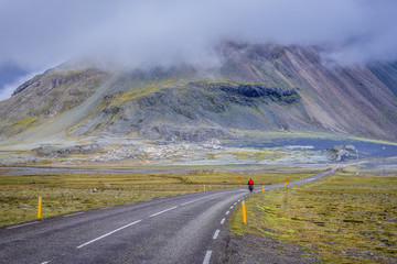 Bicyclist on national route 1 along Laekjavik coastline in Iceland