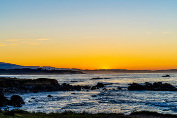 Sunrise over Ocean with Rocks, Shore, Beach 