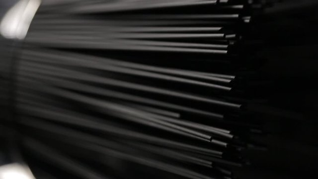 Man touches cuttlefish ink spaghetti pasta on the dark black background, close up vertical video