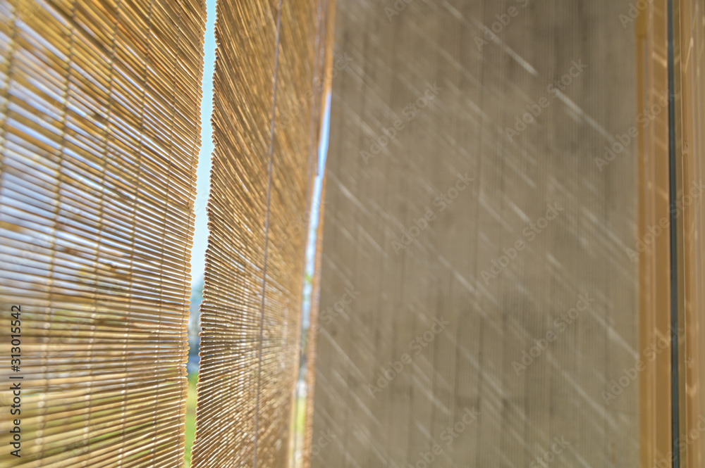 Poster selective focus pattern of bamboo blinds curtain texture background with sunlight shadow on cement w