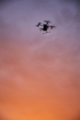 Fototapeta na wymiar inovation drone with automated external defibrilator aed flying in sunset
