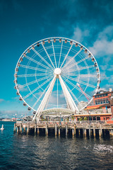 Seattle Famous Ferris Wheel in the Harbor Clouds in Sky Blue