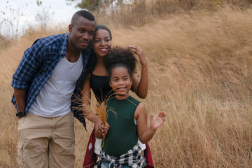 african american family, father, mother and daughter having fun together travel countryside