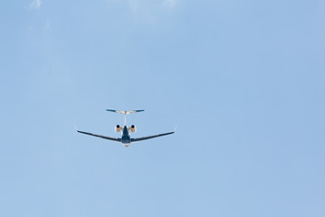 Blue jet plane with two rear turbines taking off