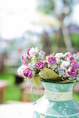 Flowers in a vase placed on a vintage wooden table