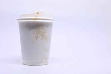 dirty brown stain on take away cup for hot coffee drink, paper mug on white background