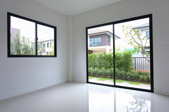 empty white clean room with glass door and window slide in new residential house